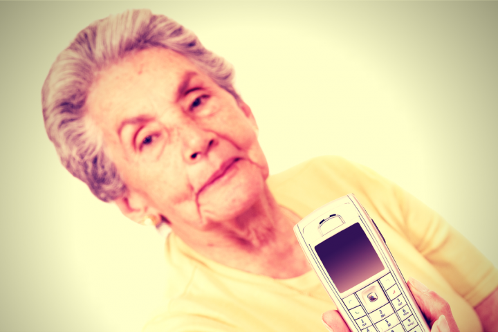 Granny holding out mobile phone