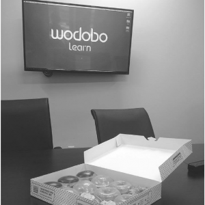 TV with Wodobo logo and pack of donuts