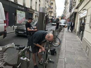 Man trying to unlock street bike in Paris