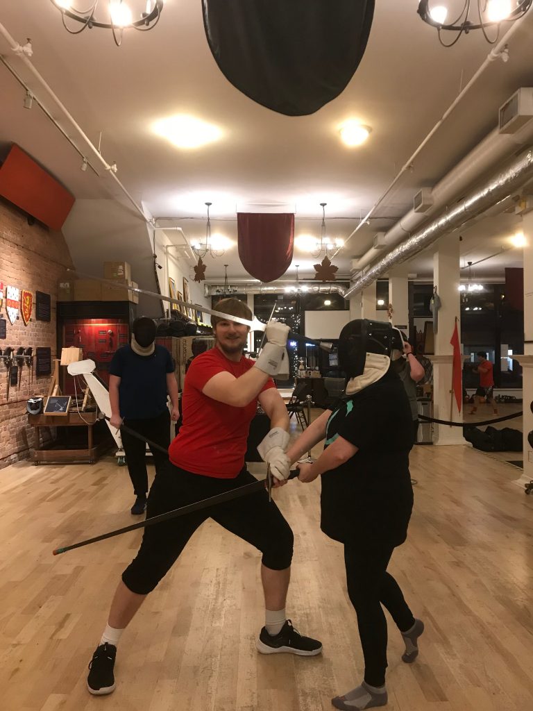Jillian sword fighting with instructor